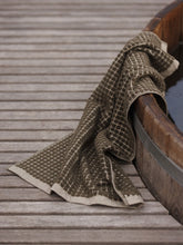 Load image into Gallery viewer, Brown textured towel draped over a wooden railing on a wooden deck